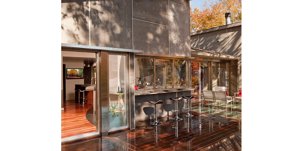 For a modern home with an open floor plan, consider a wood deck that feels like an extension of the interior flooring. This decking was laid out in the same direction as the interior wood flooring and stained in a complementary color tone. When the large sliding doors are open everything flows together as one. Photo courtesy of: Steven Paul Whitsitt