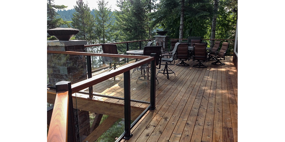 Adding a wood top cap to the modern glass and steel handrail was a great way to soften the look and tie everything together with the natural vibe of the wood deck.
Photo courtesy of: Edwards Smith Construction